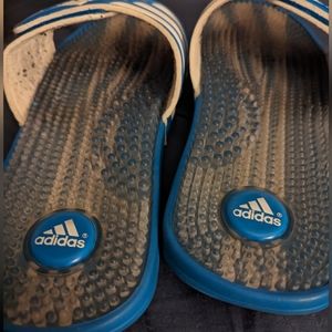 Well worn women's blue Adidas slides